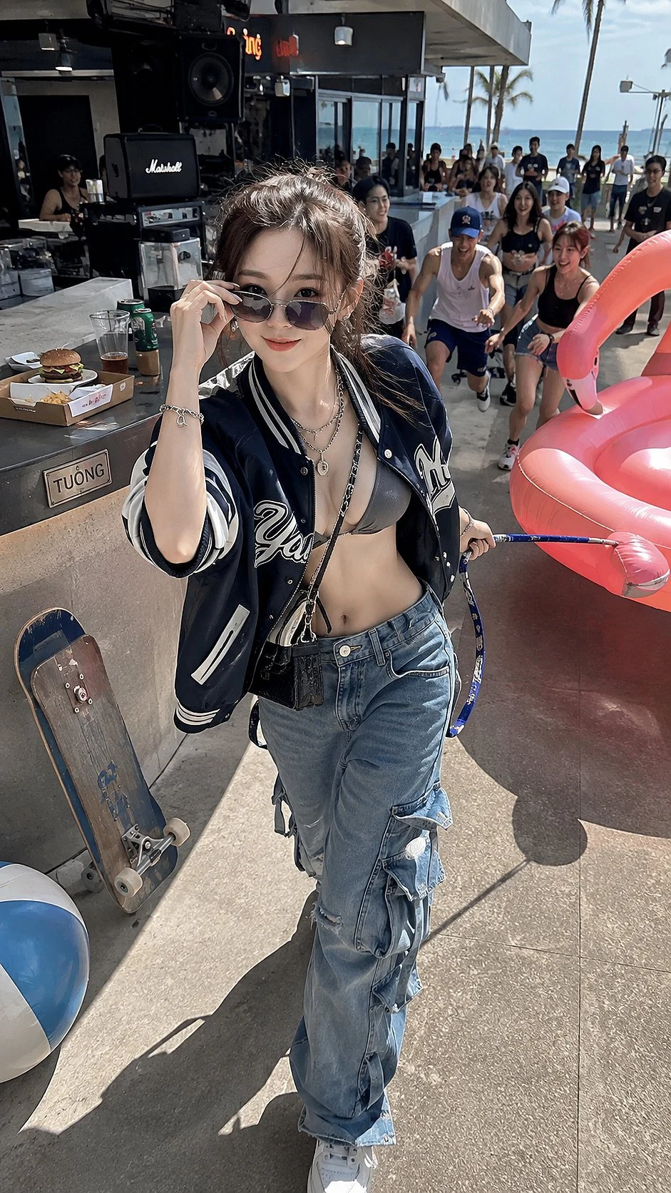 A woman in sunglasses, a dark leather jacket and jeans poses beside cars and a crowd at an outdoor event.